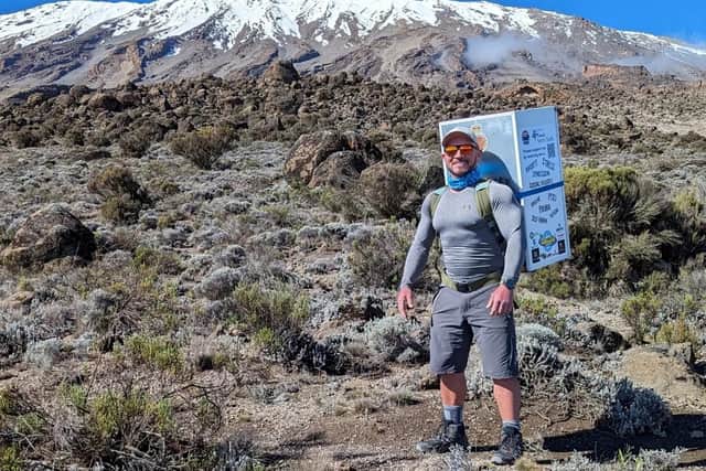 man climbs kilimanjaro