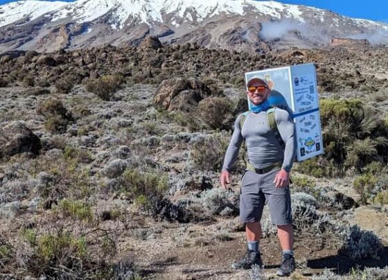 man climbs kilimanjaro